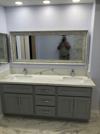 Bathroom marble tile, countertops, large mirror, gray vanity