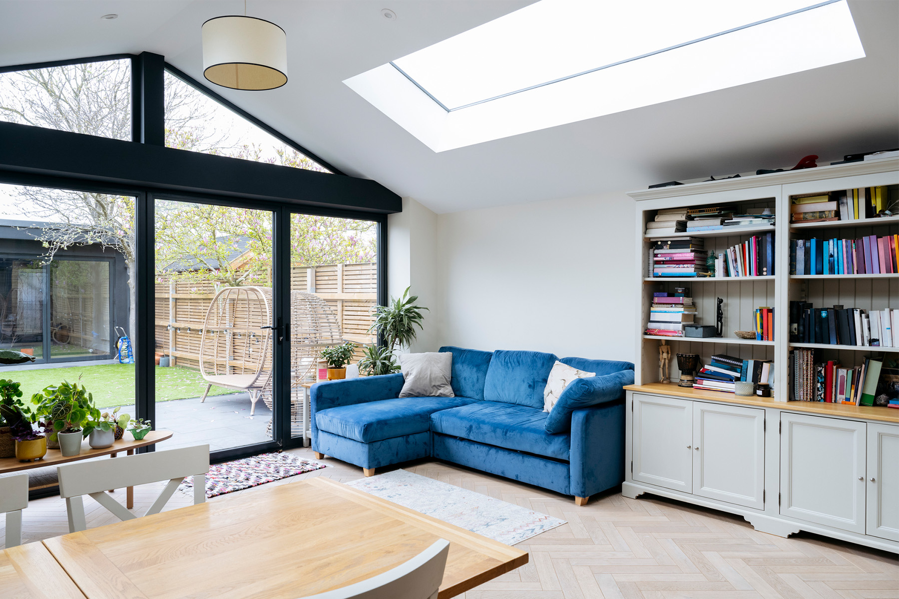 renovated living room with wall sized window looking out at ADU